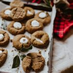 cookies on white paper beside red and white checkered textile