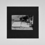 grayscale photo of man and woman on white table